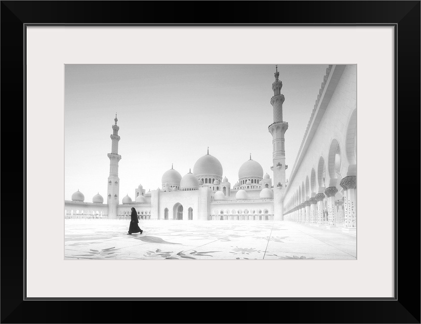 A woman walks in the courtyard of a mosque in Abu Dhabi.