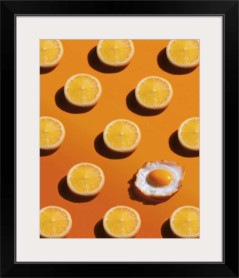 Lemon slices pattern with a fried egg, yellow background, abstract, surprise concept.