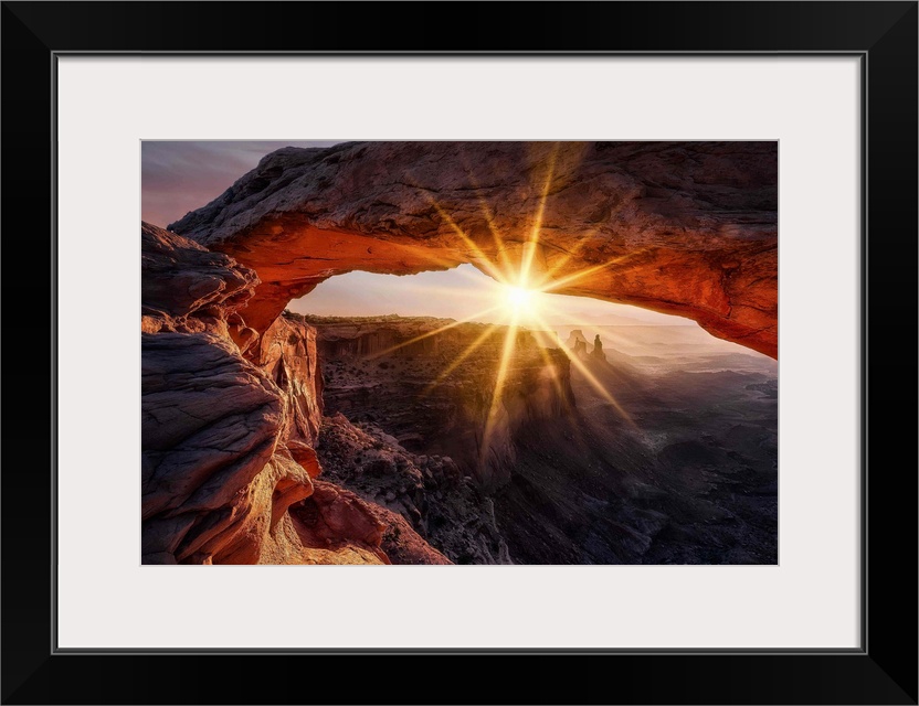 A view through the Mesa Arch in the Canyonlands national park in Utah at sunrise.