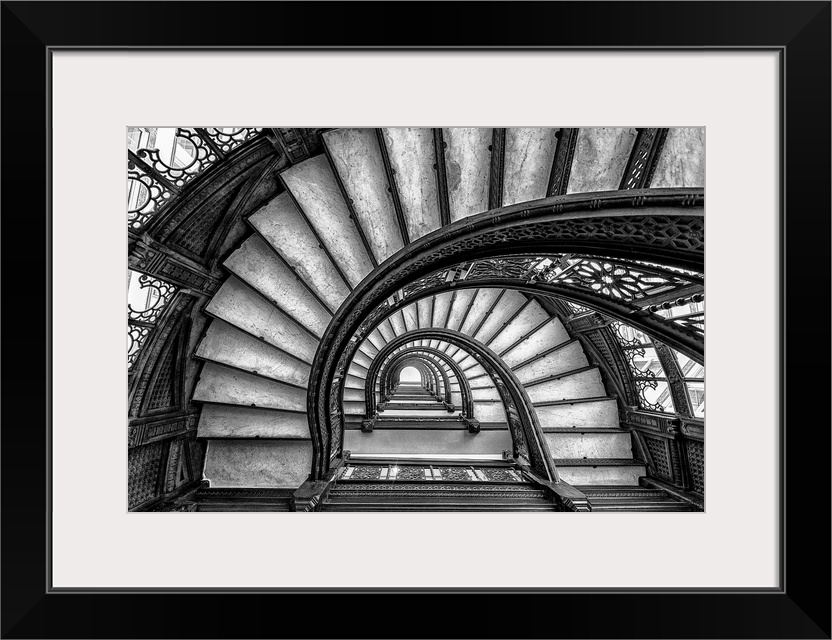 Black and white abstract photograph of a winding staircase.