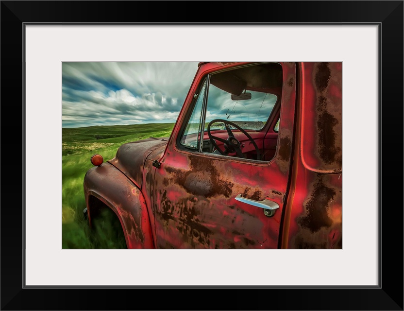 Long exposure of clouds drifting by over an abandoned truck in a rural area, Saskatchewan, Canada.