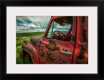 Clouds drifting by over an abandoned truck in a rural area, Saskatchewan, Canada