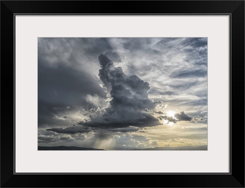 Cumulonimbus cloud building over the city of Cochabamba, Bolivia. Inspirational lighting coming from behind the cloud, Coc...