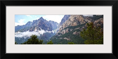 Dramatic mountain landscape fringed by forest, Corsica