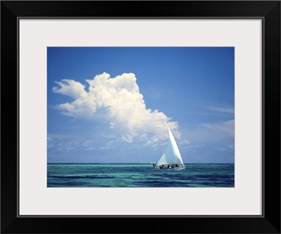 Fishermen In Dhow Sailing In Shallow Water In Front Of Large Thunder Storm Cloud