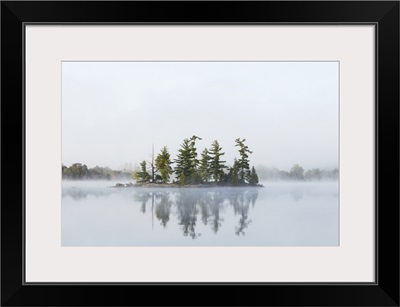 Fog shrouds a small island on Turtle Lake in Ontario's Muskoka Region, Ontario, Canada