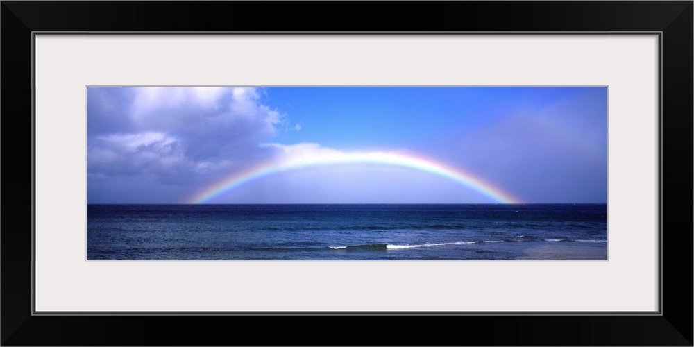 Full Rainbow Over Ocean, Large Clouds Against Blue Sky