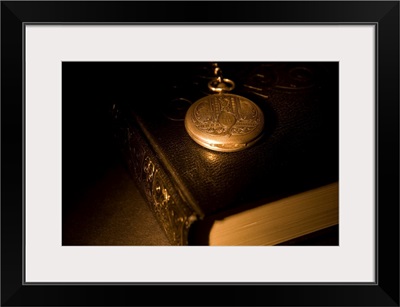Gold Pocket Watch Resting On A Book