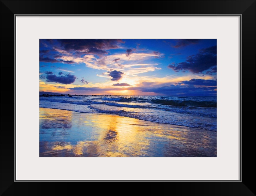 Horizontal photograph on a large wall hanging of a vivid sunset glowing through clouds, over the shore of Mokapu Beach in ...