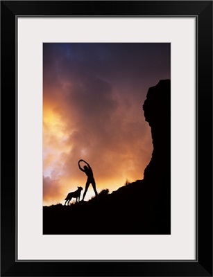 Hawaii, Silhouette Of A Woman Stretching On A Mountain Top At Sunset