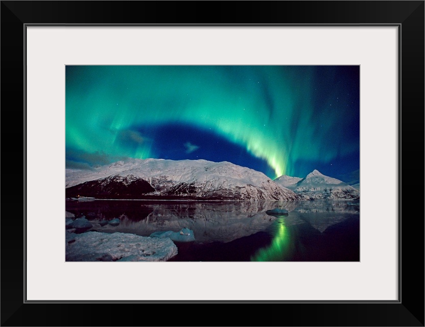 Canvas photo art of northern lights in the sky above snow covered mountains near water.