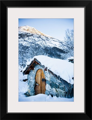 Norway, Sognefjord, snow covered traditional stone building