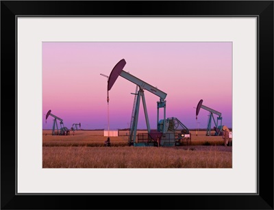 Oil Pump Jacks On Canadian Prairie At Dusk, Carlyle, Saskatchewan, Canada