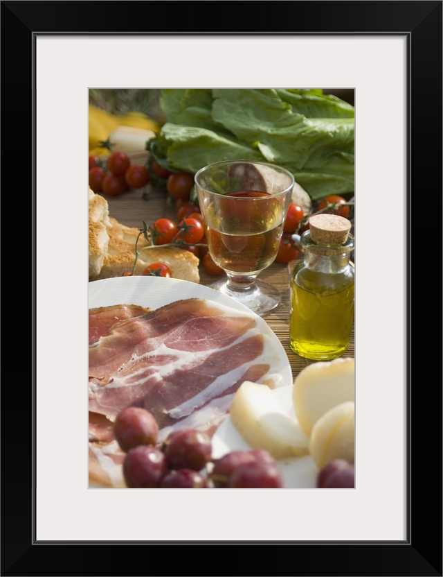 Prosciutto Ham, Cheese, Tomatoes, White Wine And Other Ingredients For A Picnic In Tuscany, Italy