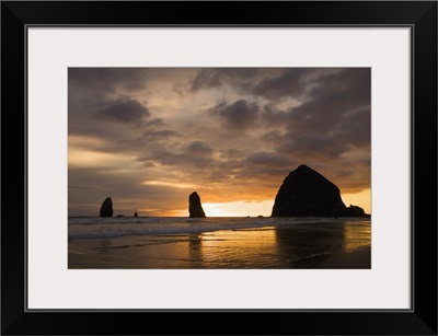 Silhouette Of Rock Formations At Sunset; Cannon Beach, Oregon, USA