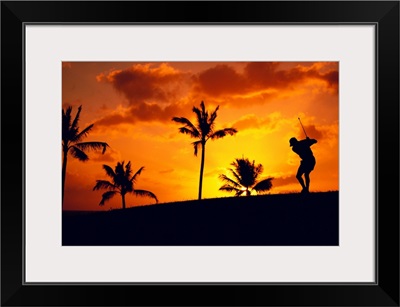 Silhouetted Golfer In Dramatic Orange Sunset Sky