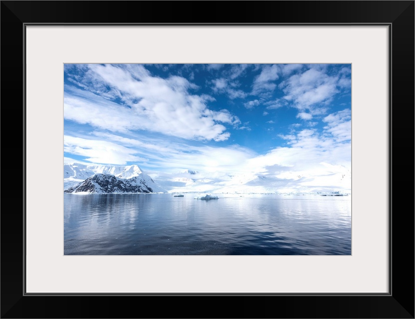 Sky reflected in water in Neko harbor, Antarctica.