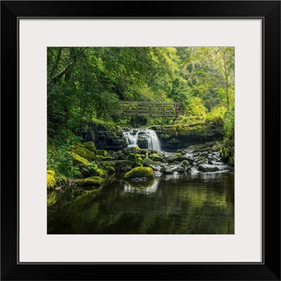 Small Waterfall Flowing Beneath A Rustic Wooden Bridge, Alston, Cumbria, England