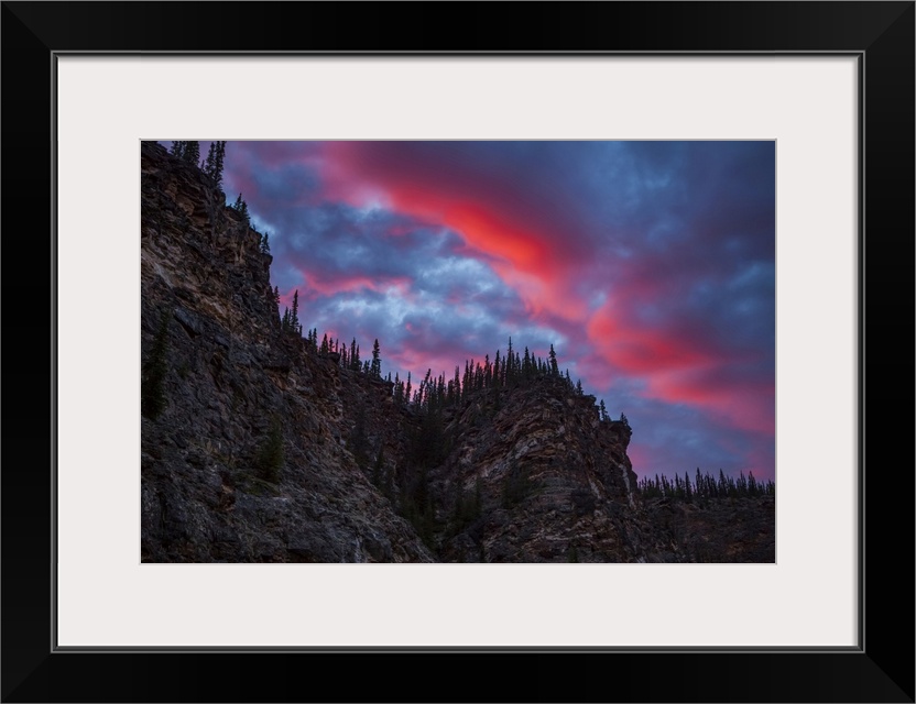 Sunset rolls into sunrise during early June just below the Arctic Circle on the Charley River, Alaska, United States of Am...