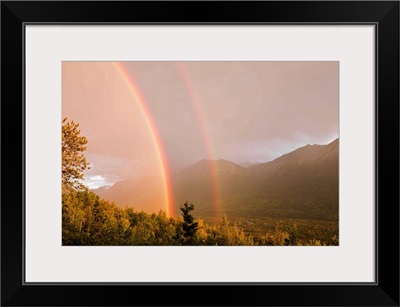 Sunset view of a double rainbow arching over Eagle River Valley after a passing storm, Southcentral Alaska, Summer