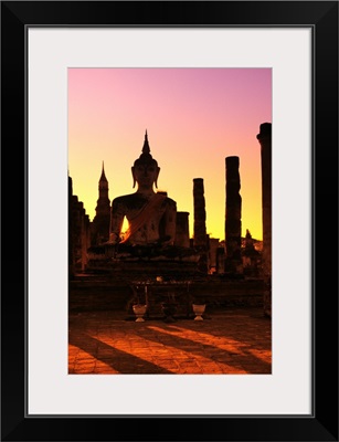 Thailand, Sukhothai, Wat Mahathat, Buddha And Pillars Backlit At Sunset