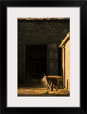 Wheelbarrow Beside A Barn