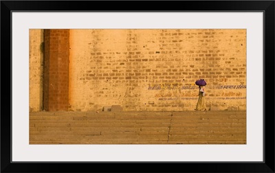 Woman Carrying Bundle On Her Head On The Ghats By The Ganges, Varanasi, India