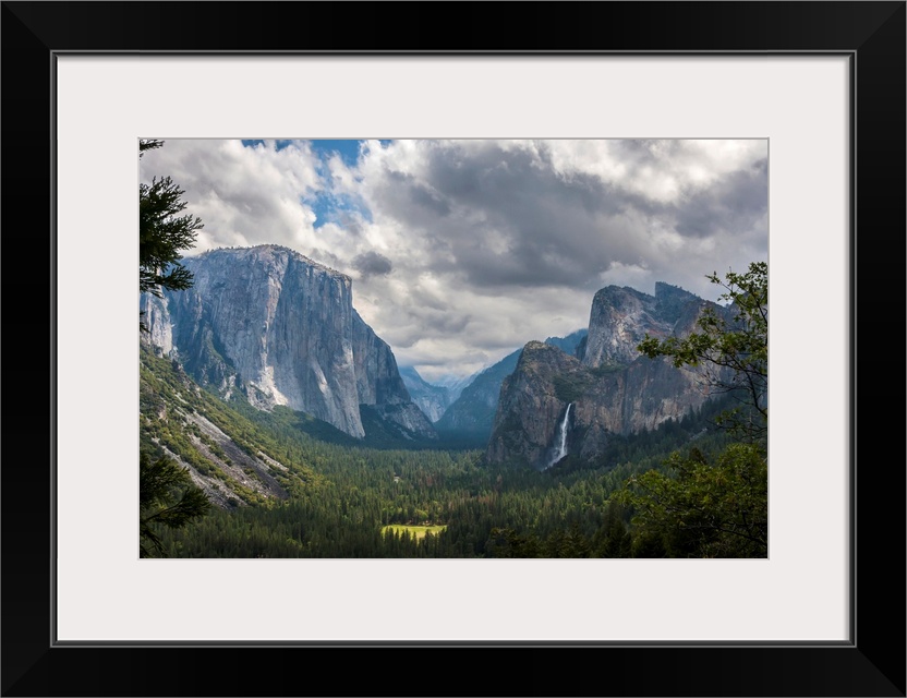 Clouds move over Yosemite Valley, with Bridalveil Falls on the right and El Capitan on the left, Yosemite National Park. C...