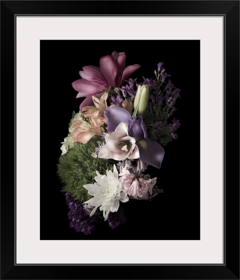 Moody photograph of a bouquet of pastel flowers on black in low light.