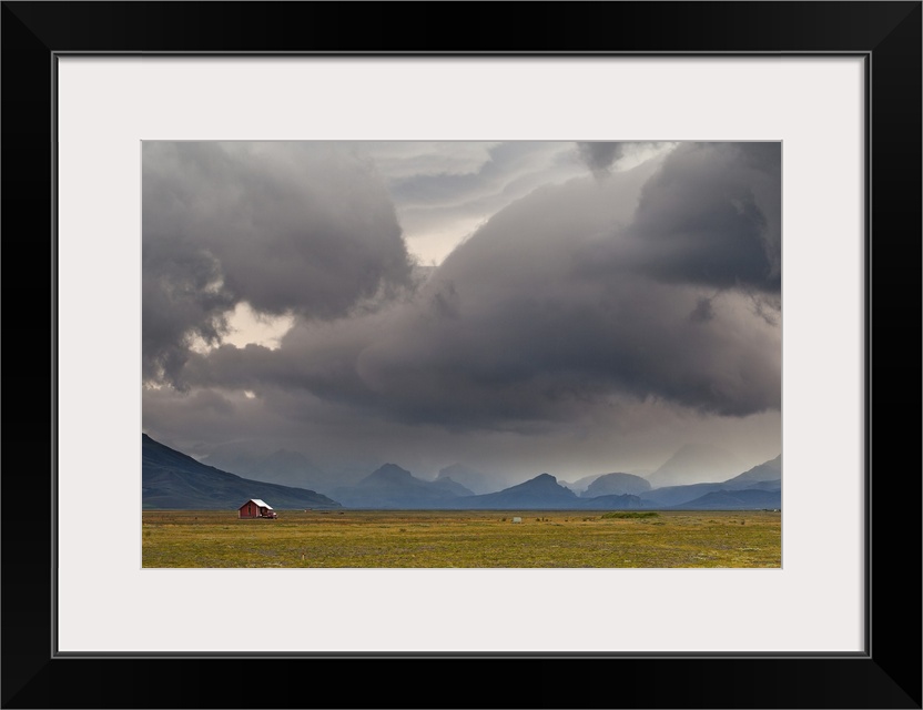 A photograph of a dramatic cloudscape hanging over an Icelandic landscape.