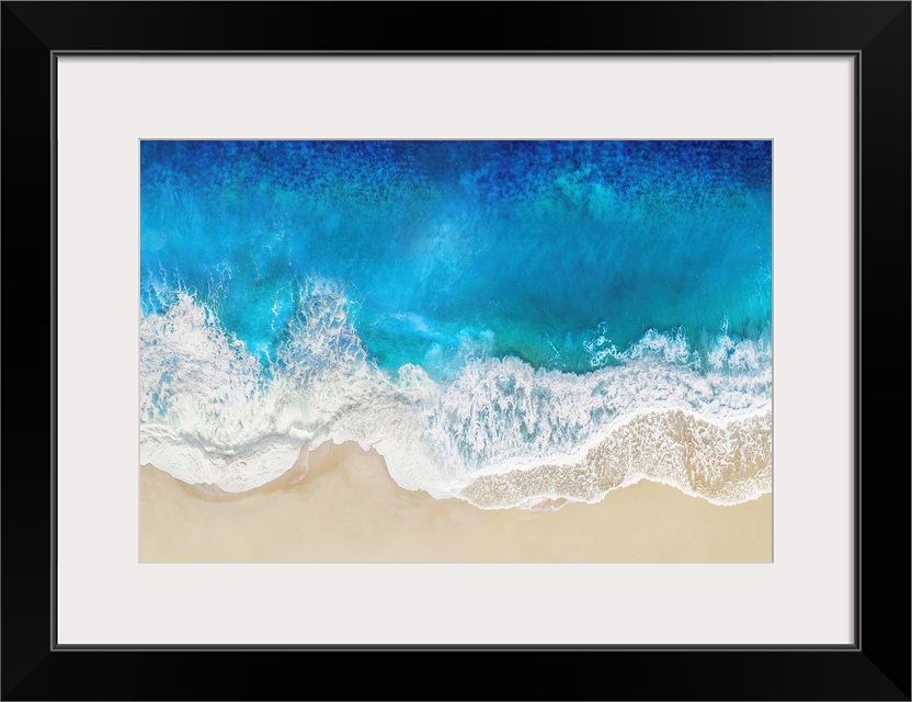 One artwork in a series of aerial shots of a beach as blue waves break upon the shore.