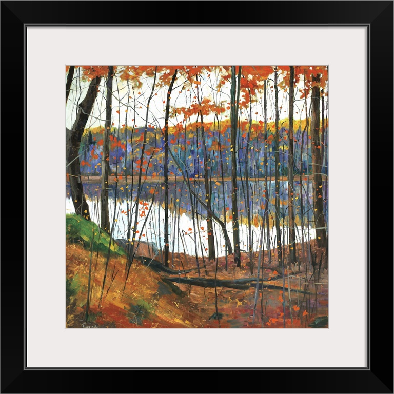 A colorful fall scene of a forest surrounding a lake with the trees reflecting in the water.