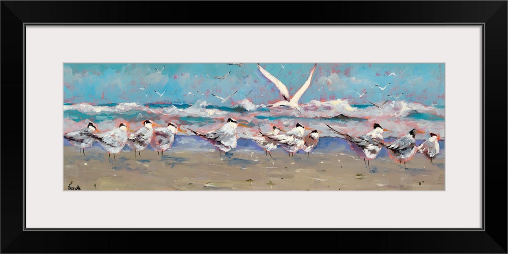 A panoramic landscape of a beach scene with a group of seagulls along the shoreline while the ocean waves hit land.