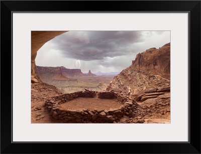 Anasazi ruins with thundercloud and lightning in background
