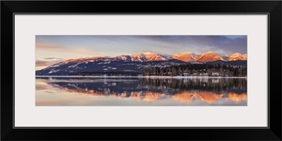 Big Mountain reflected in Whitefish Lake at sunset in winter in Whitefish, Montana