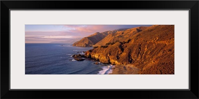 California, Big Sur, sunset casts a golden hue over the Coast Range