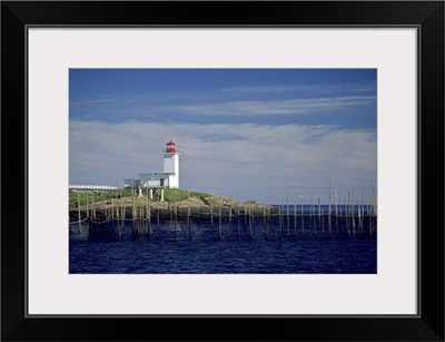 Canada, New Brunswick, Bliss Harbor, Bliss Point Light with fish weirs