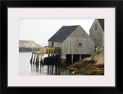 Canada, Nova Scotia, Peggy's Cove. Lobster traps on typical wooden dock