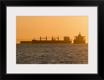 Cargo ship silhouettes in English Bay Beach, Vancouver, Canada