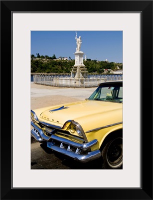 Classic Dodge 50's auto in front of statues, Havana, Cuba