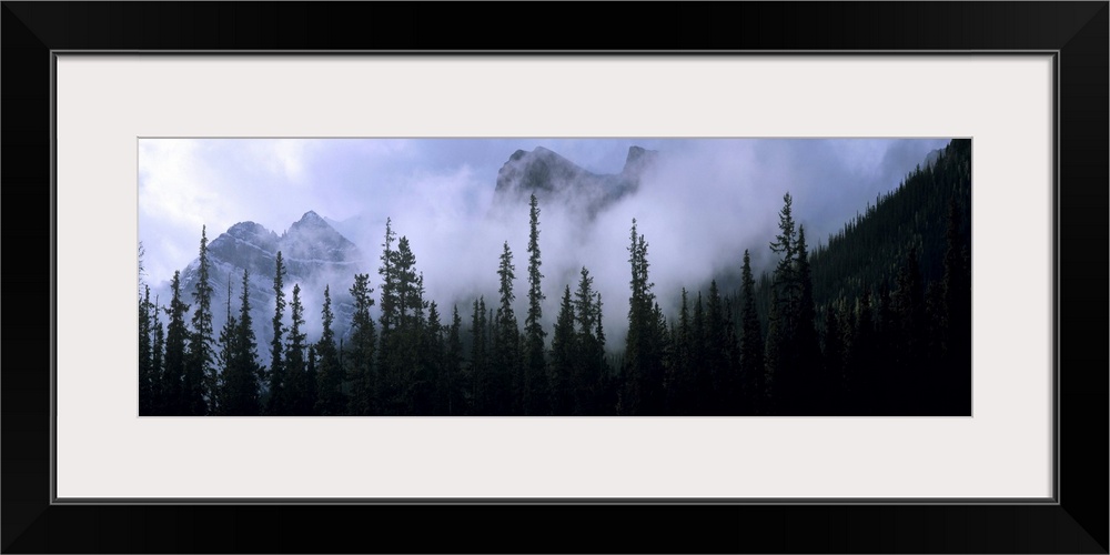 Canada, Alberta, Banff NP. Clouds swirl around mountain peaks above Lake Louise Junction in Banff NP, a World Heritage Sit...