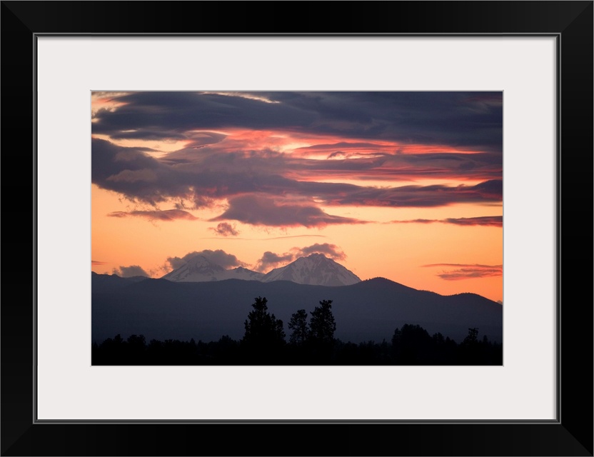 USA, Oregon, Bend. Clouds gather around the Soth and Middle Sisters at sunset in Deschutes County, Oregon.