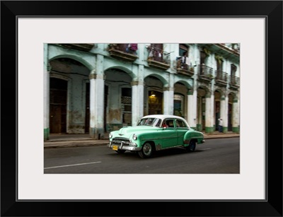 Cuba, Havana, classic green car and arches of colonial building