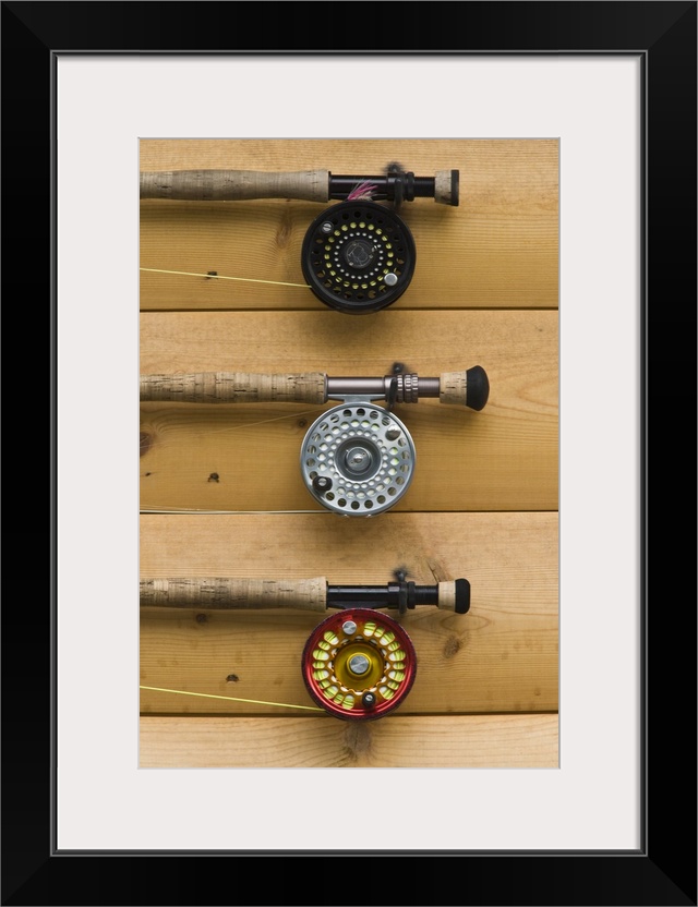 USA, Alaska, Silver Salmon Creek Lodge. Fishing rods wait for customers on the wall of the lodge.