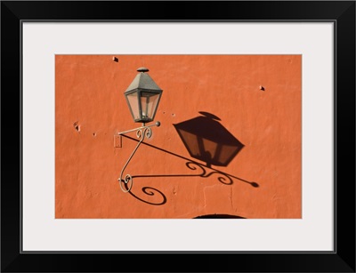 Guatemala, Antigua, lantern with shadow on a colorful wall in the town of Antigua