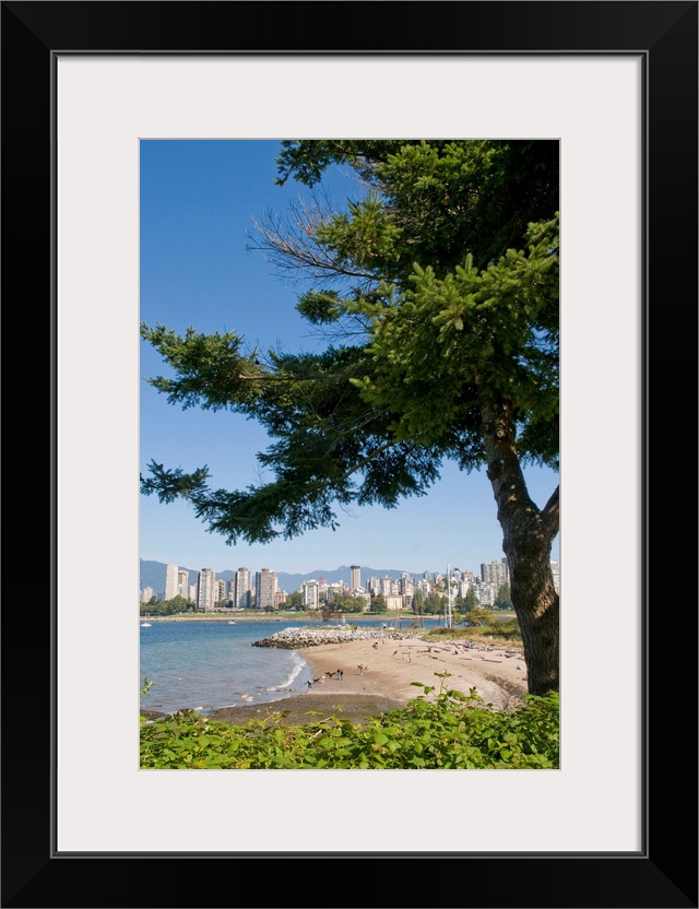 Kitsilano Beach park overlooking English Bay and the skyline of downtown Vancouver, BC, Canada.