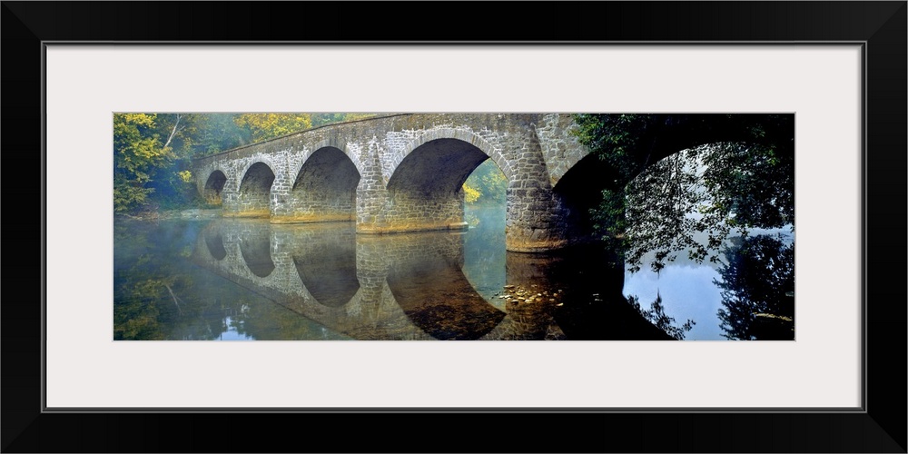 USA, Maryland, Hagerstown. Mist the lovely reflection of the stone curves of Wilson Bridge, at Hagerstown in Maryland.