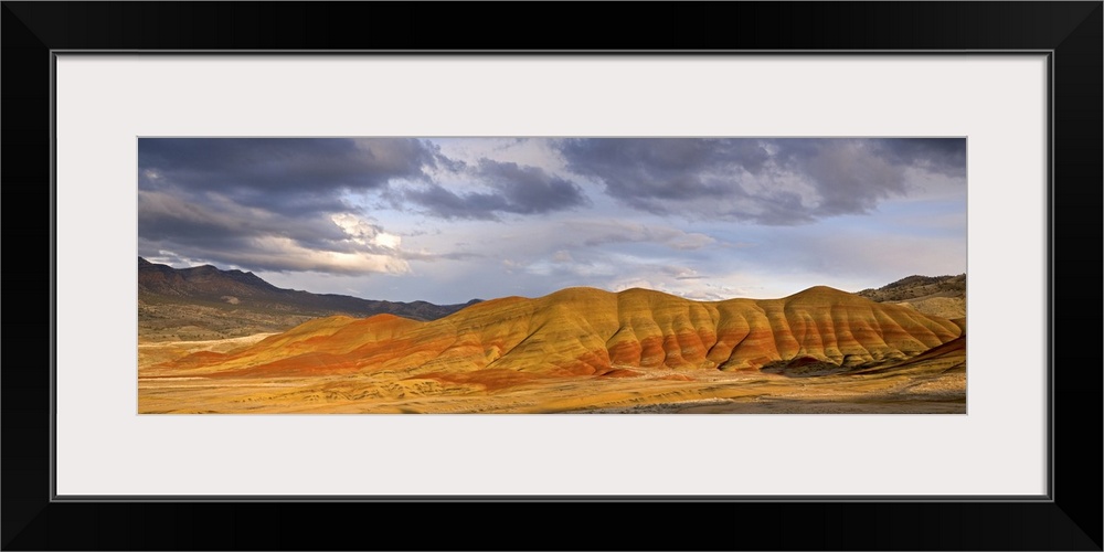 USA, Oregon, John Day Fossil Beds National Monument. Panoramic of the Painted Hills and storm clouds.