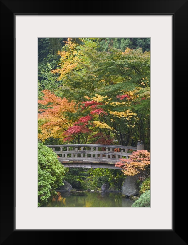 USA, Oregon, Portland. Wooden bridge over pond at Portland Japanese Garden.