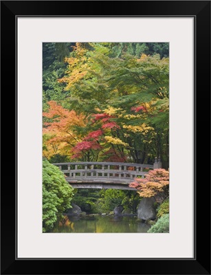 Oregon, Portland. Wooden bridge over pond at Portland Japanese Garden